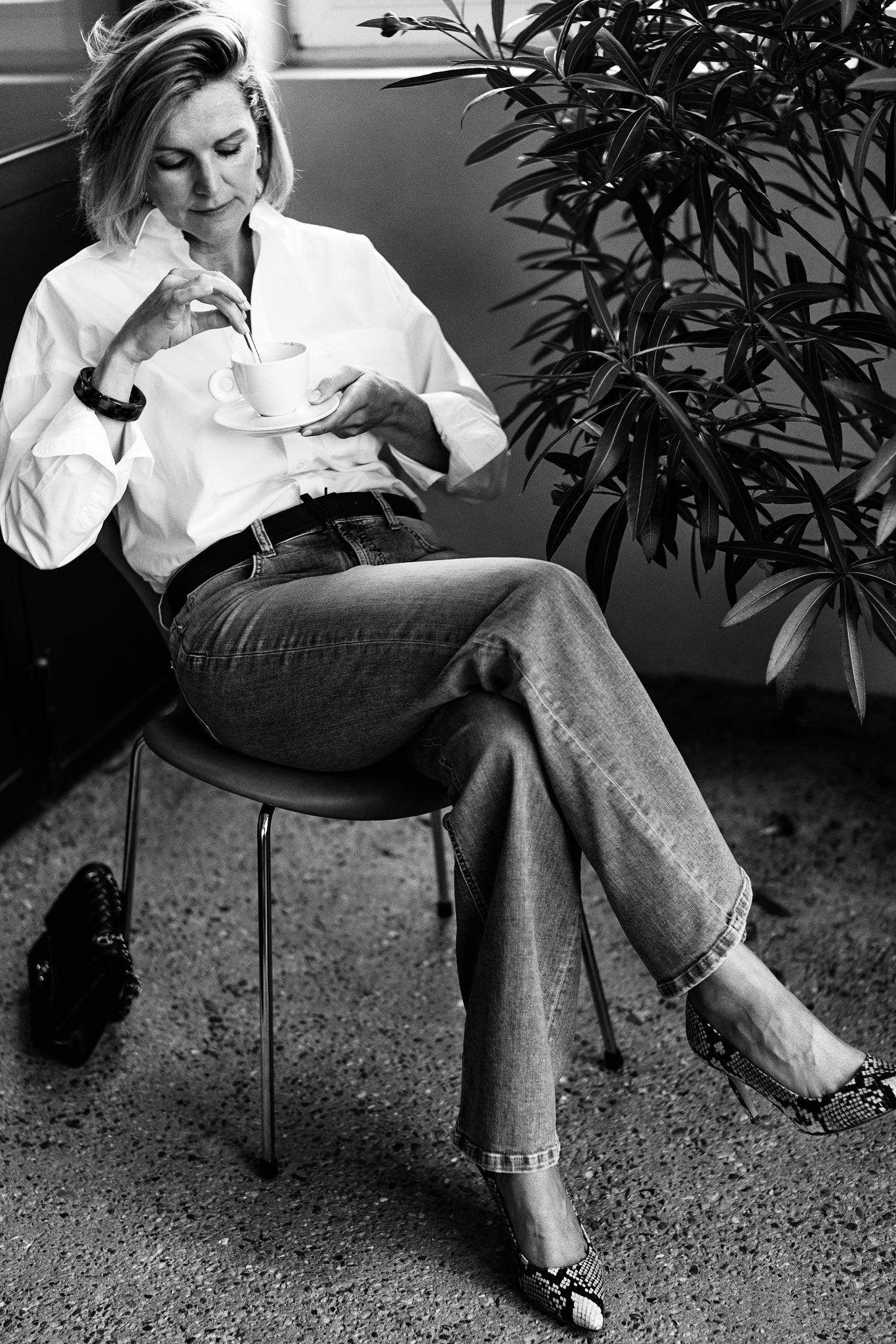 woman having coffee wearing python high heels and reversible belt