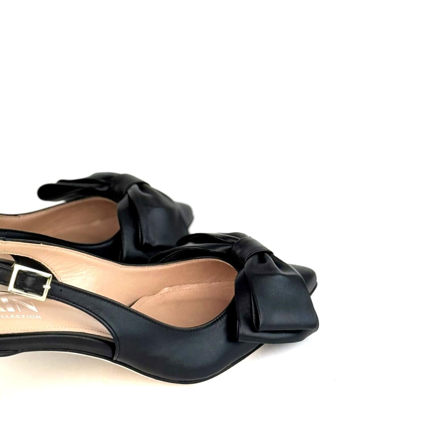 Black low-heeled kitten slingback shoes with bow details on a white background