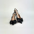 Black kitten heel sling back heels with bow details on a white background