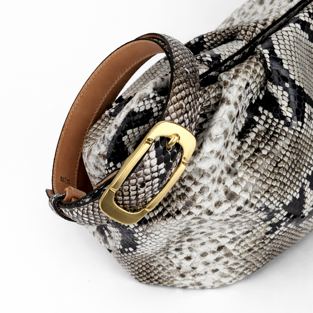 Faux Python handbag with matching belt on a white background