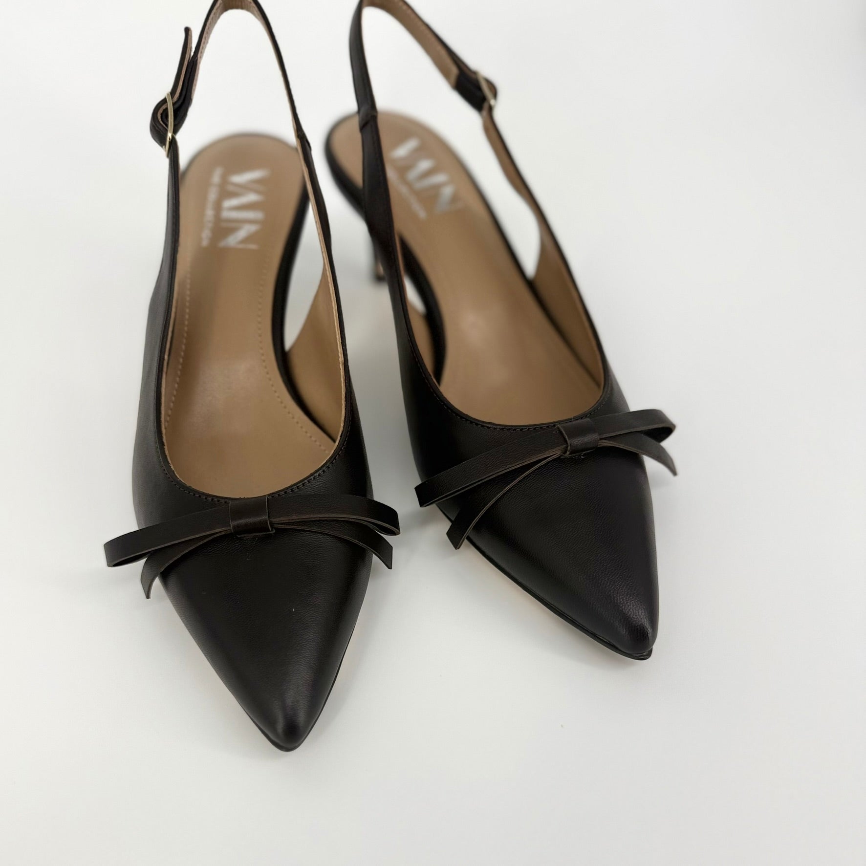 A pair of rich dark brown leather slingback pointed-toe pumps with kitten heels, displayed on a clean light gray background.