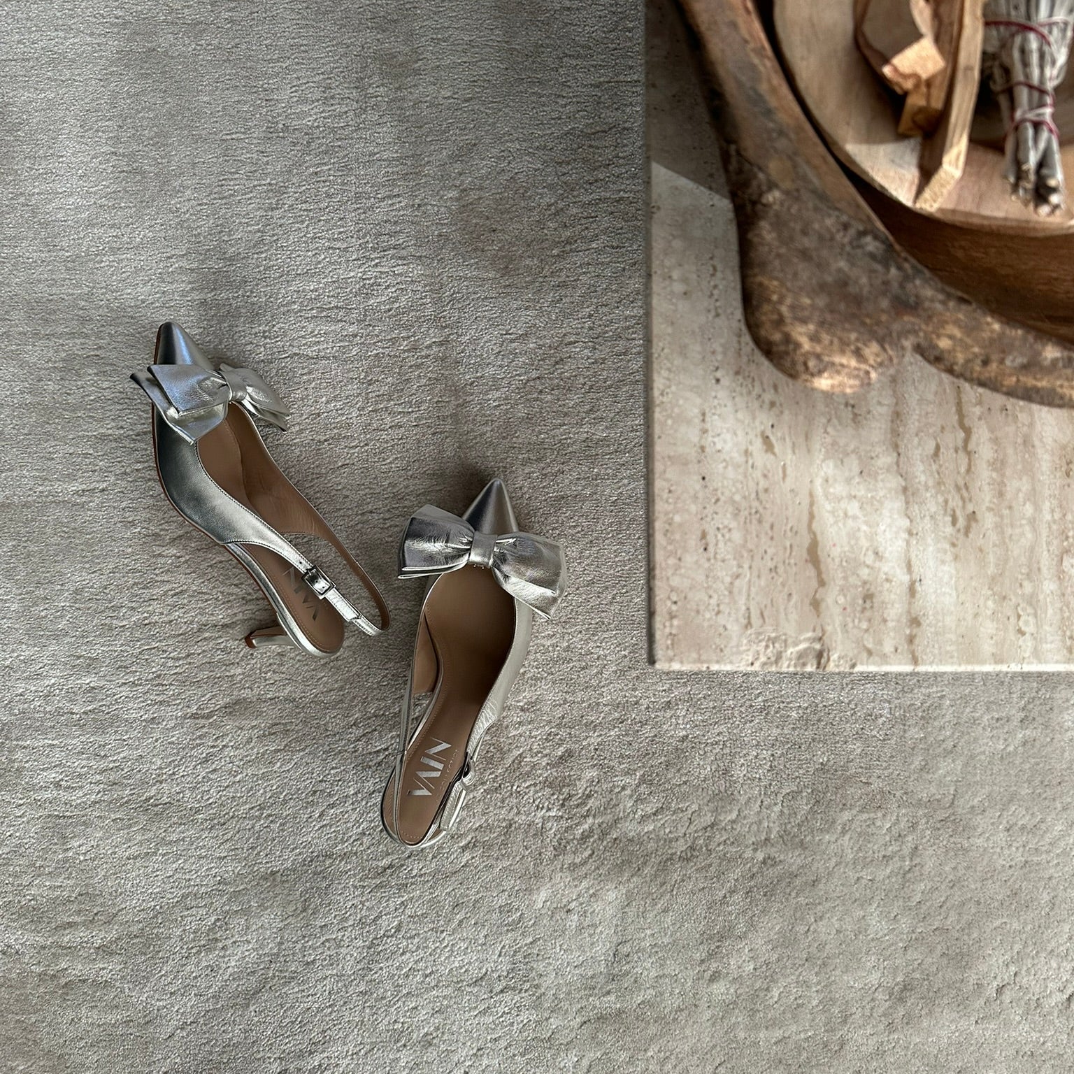 champagne kitten heels slingbacks on carpet next to decoration