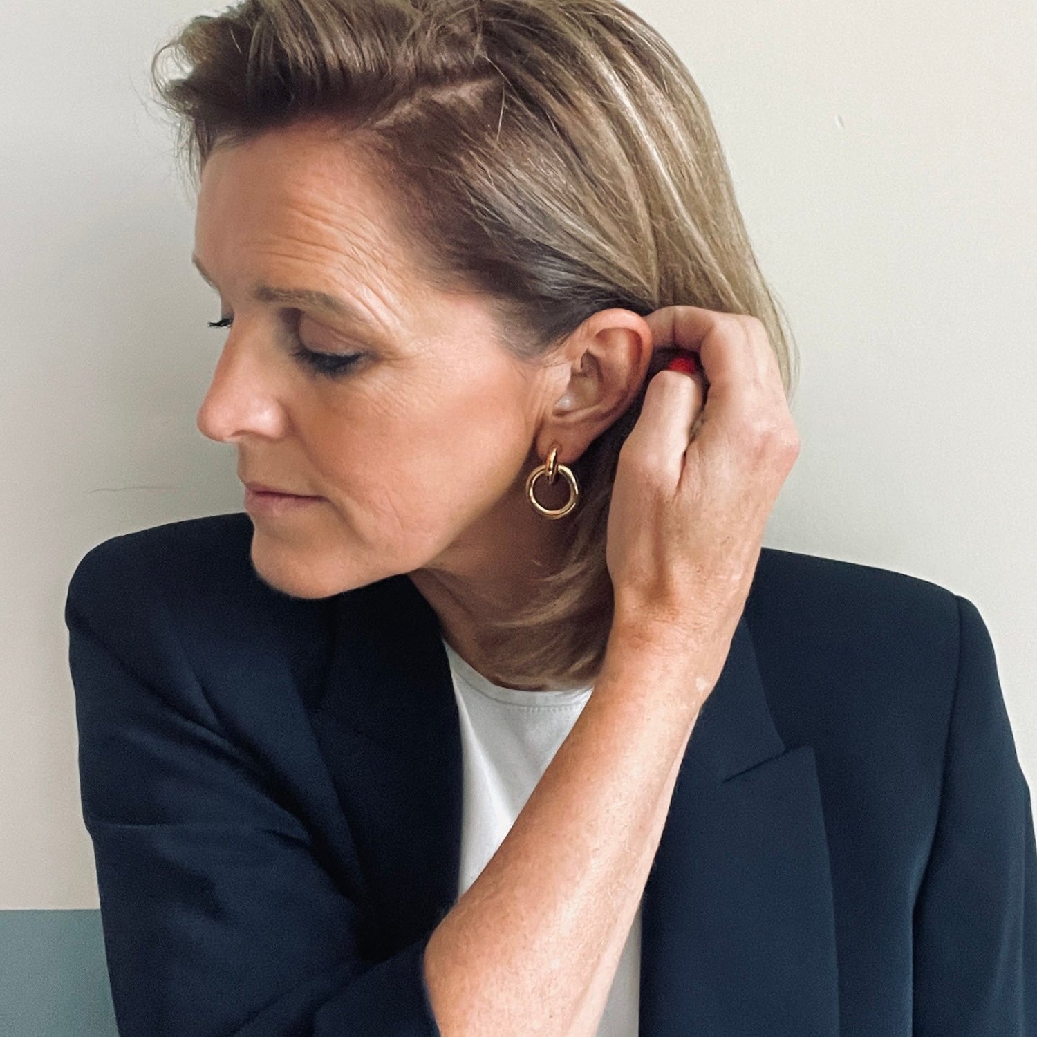 woman wearing gold earring loops