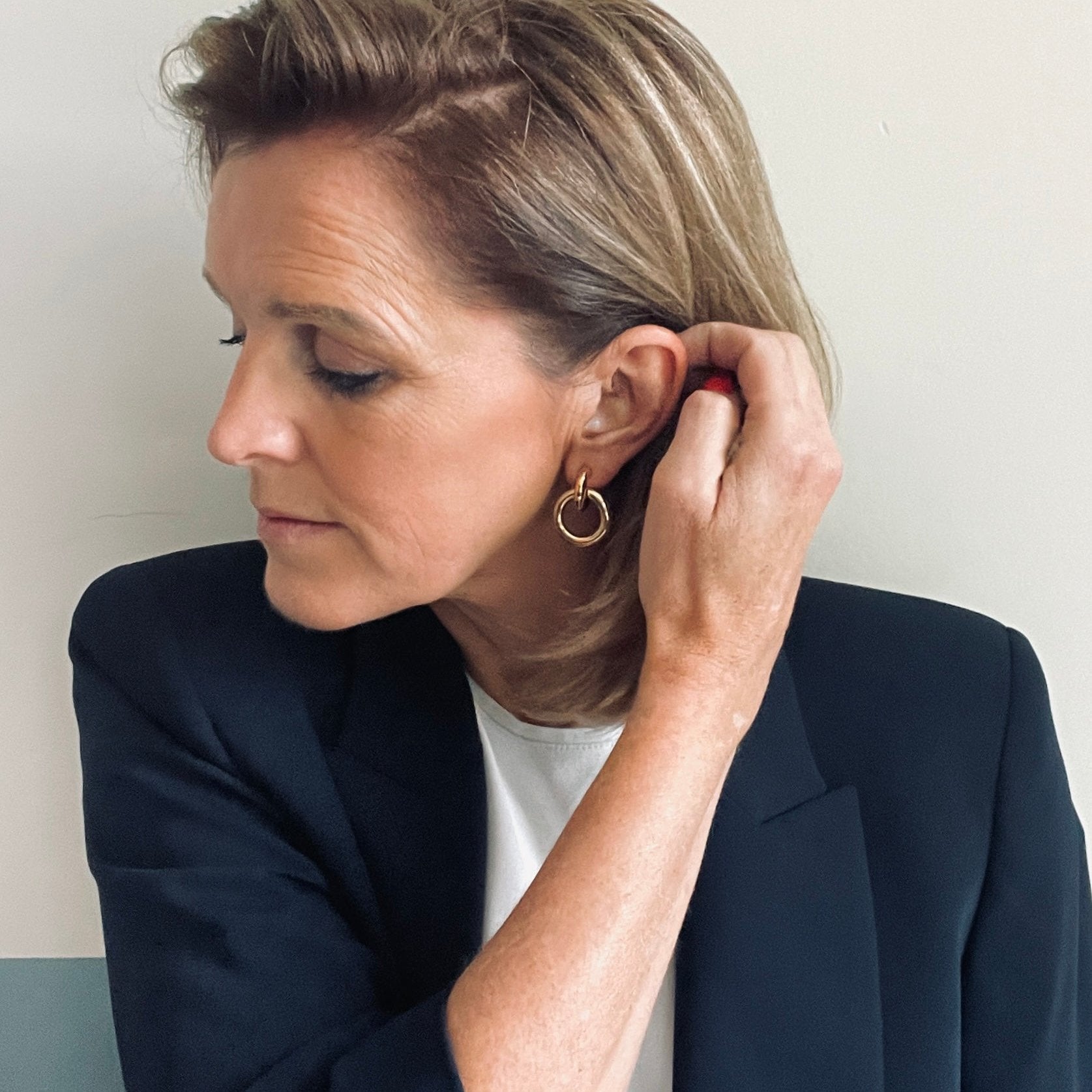 woman wearing gold earring loops