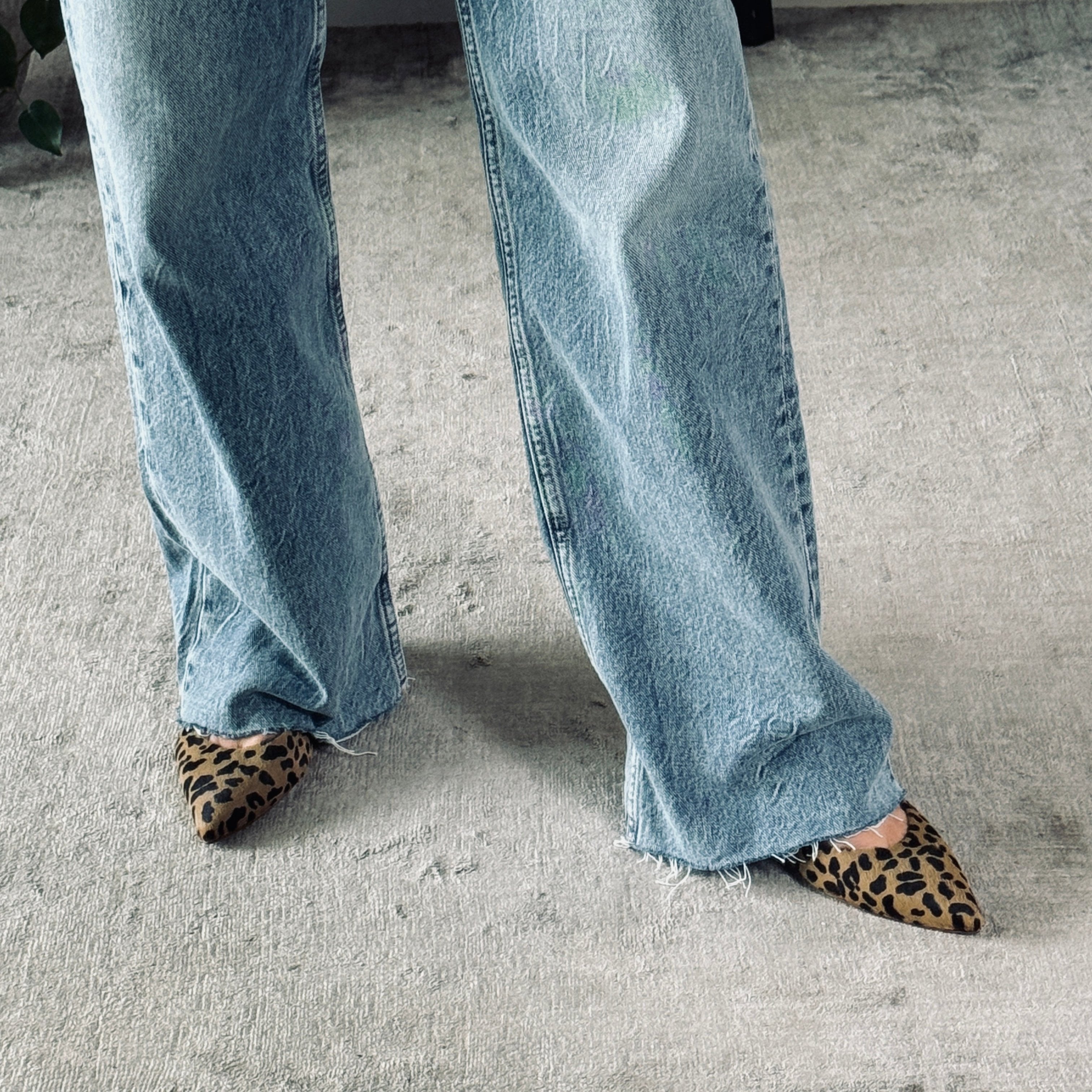 Woman wearing slingback kitten heels leopard print