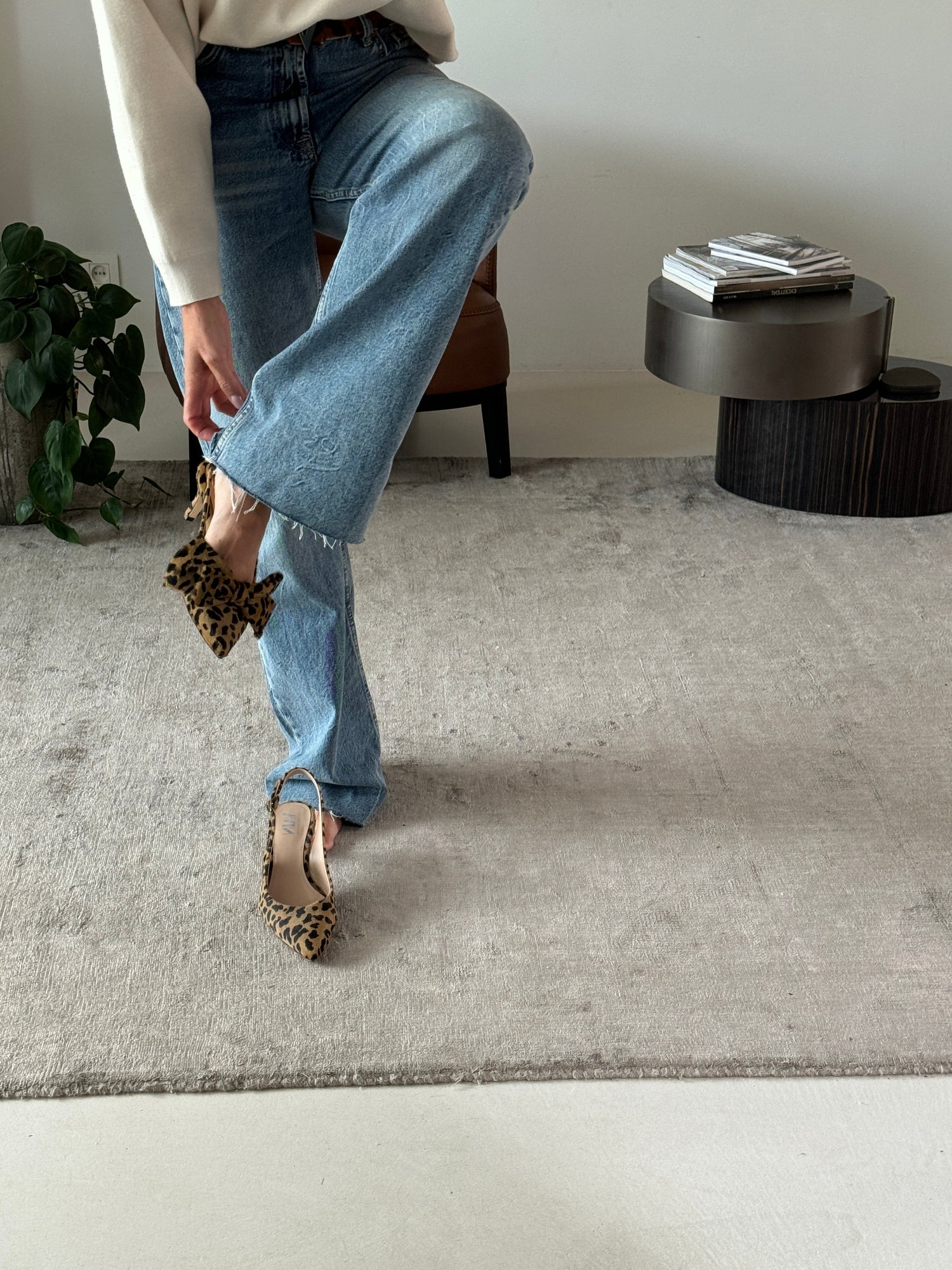 woman fitting on slingback kitten heels one with bow and one without bow