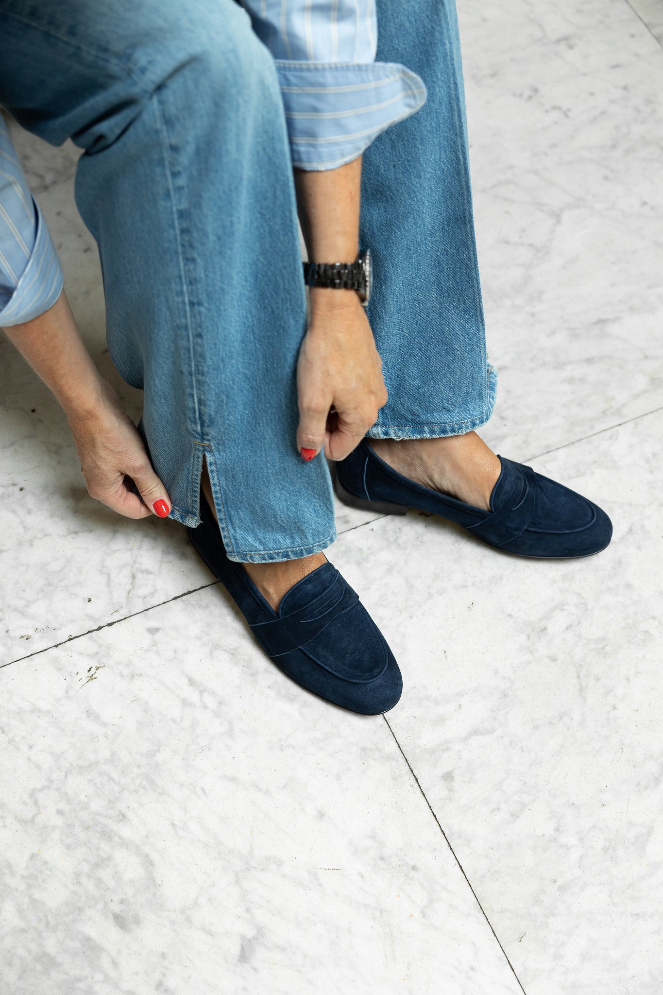 Woman wearing blue suede loafers
