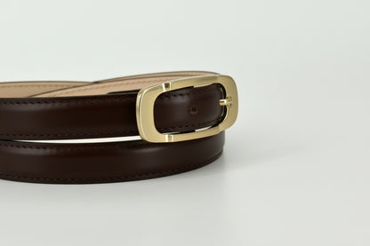 A close-up of a dark brown leather belt with a polished gold-tone metal buckle, showing the inner tan lining, set against a plain light gray background.
