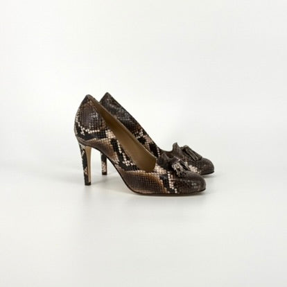 side view from a pair of high heels with soft almond tip in a black and brown python print on a white background