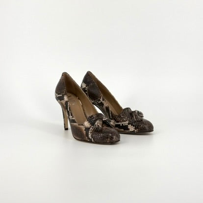 side view from a pair of high heels with soft almond tip in a black and brown python print on a white background