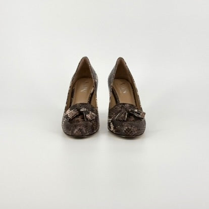 front view of high heels in a printed brown and black python. the brand "VAIN" is visible on the sole inside the shoes.