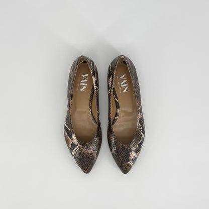 A pair of pointed-toe flats with a brown, black and beige snakeskin pattern, shown from a top-down view on a light gray background. The brand name &