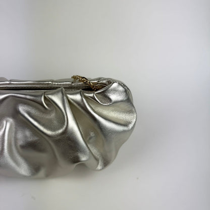 Champagne metallic clutch bag on a white background