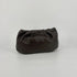 Large soft nappa leather clutch in dark brown with metallic strap on a white background