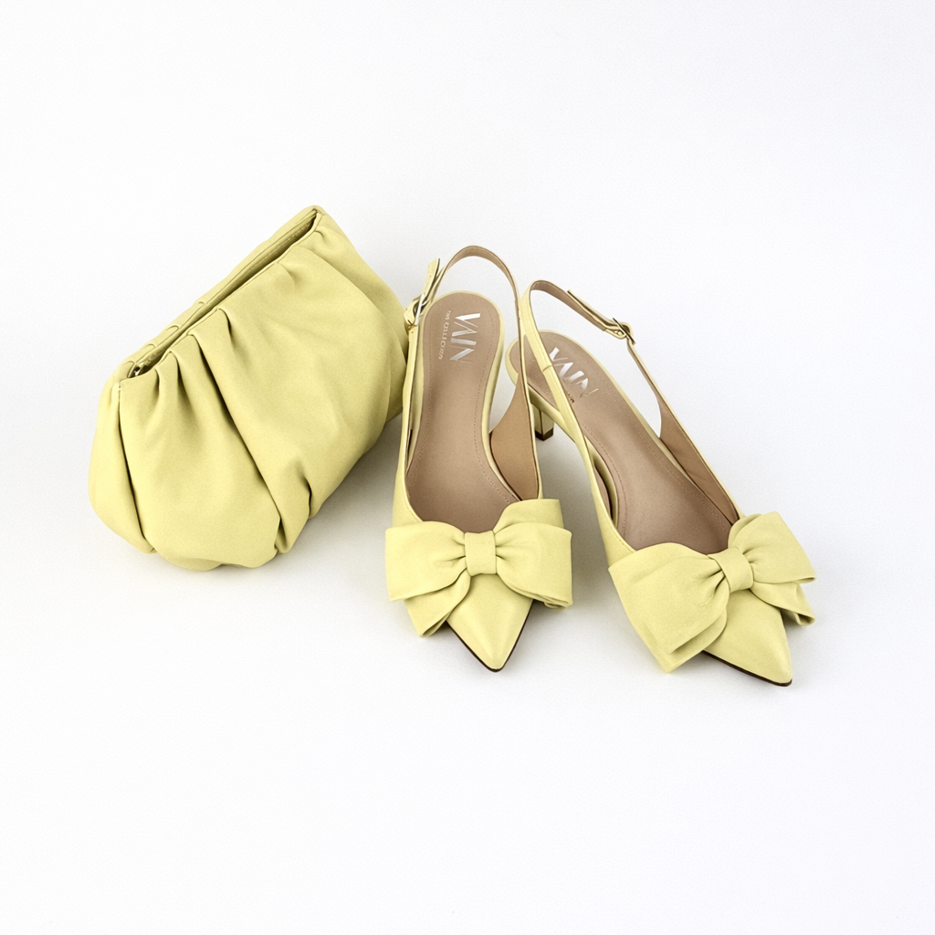 Lemon Meringue Yellow coloured shoes with bow details and a matching clutch on a white background
