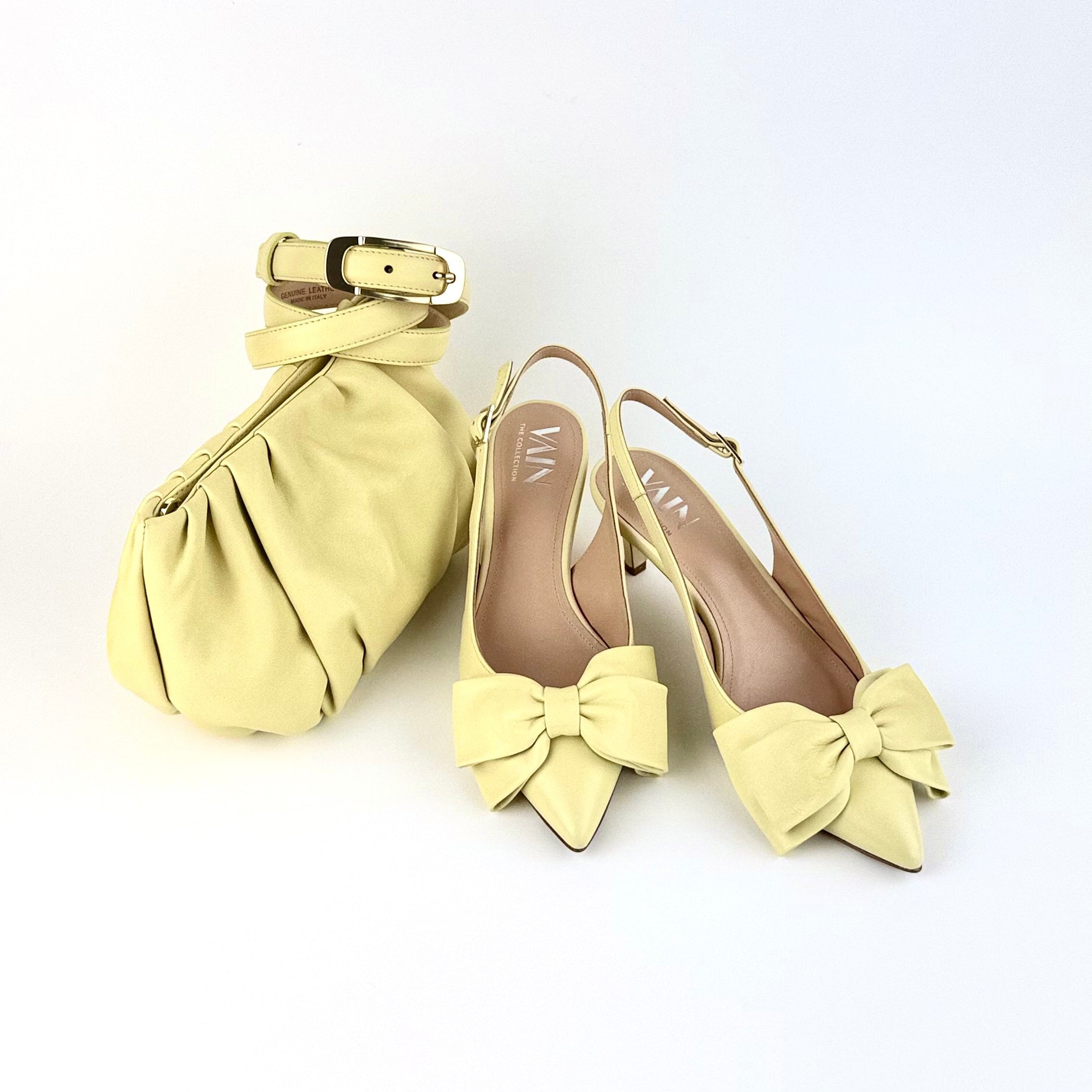 Lemon Yellow handbag and low heels with bow details on a white background