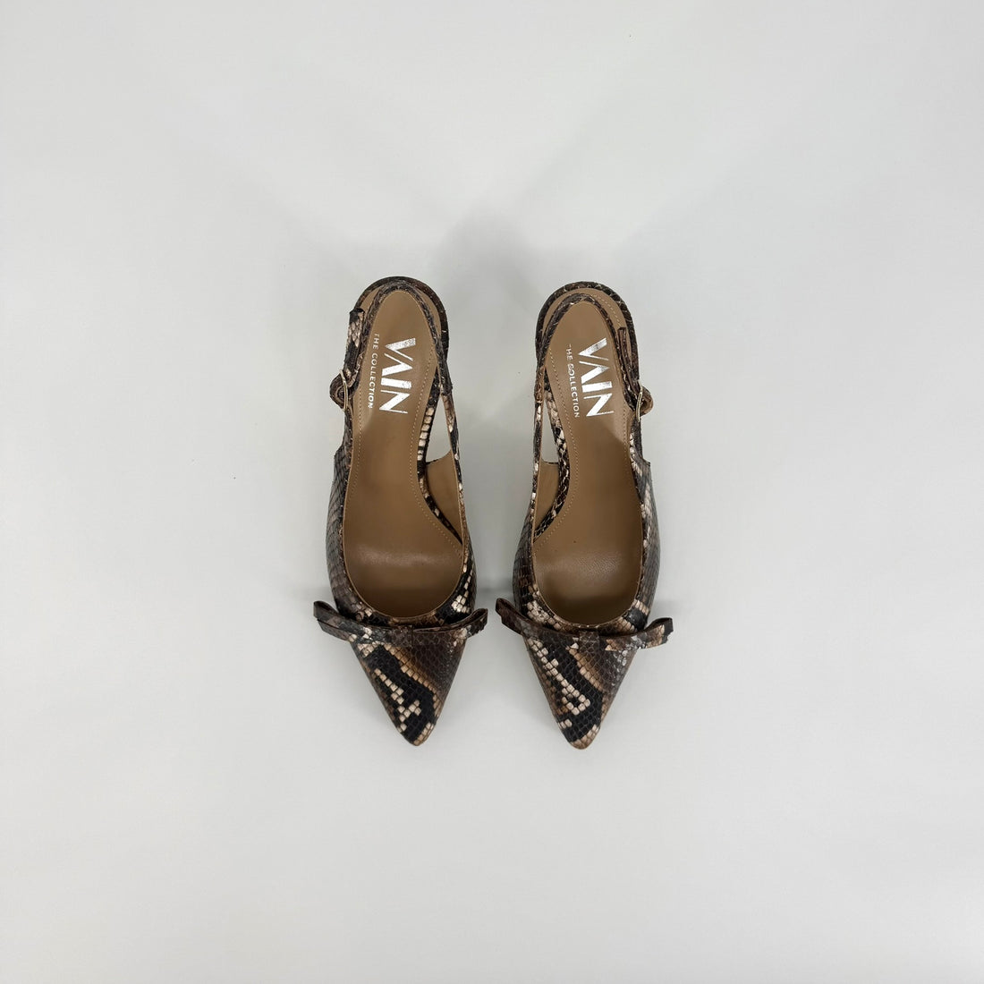 A pair of pointed-toe slingback pumps featuring a brown and black snakeskin pattern, displayed on a light gray background.