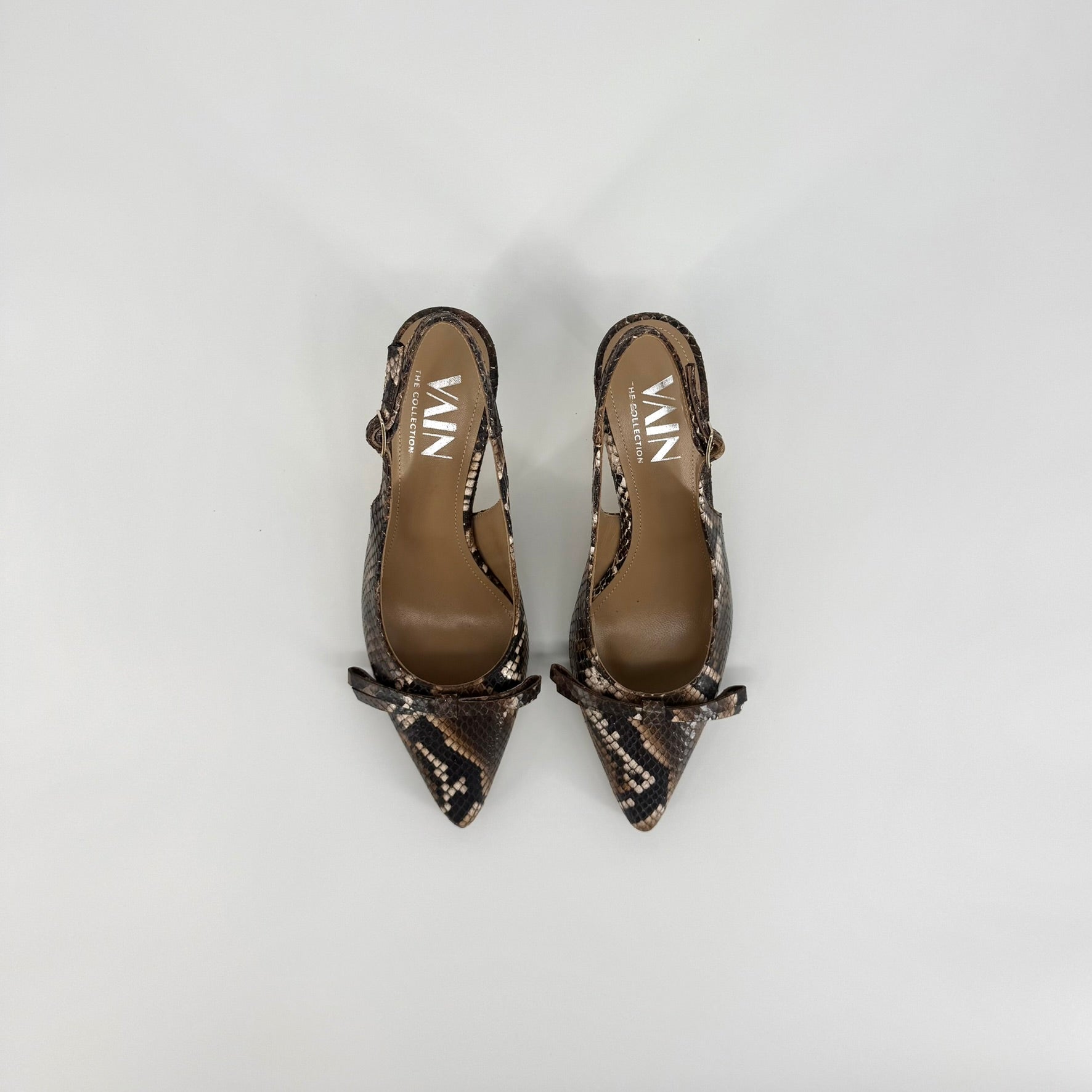 A pair of pointed-toe slingback pumps featuring a brown and black snakeskin pattern, displayed on a light gray background.