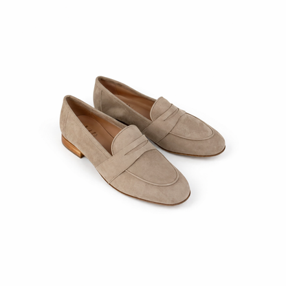 Pair of beige loafers for women on a white background