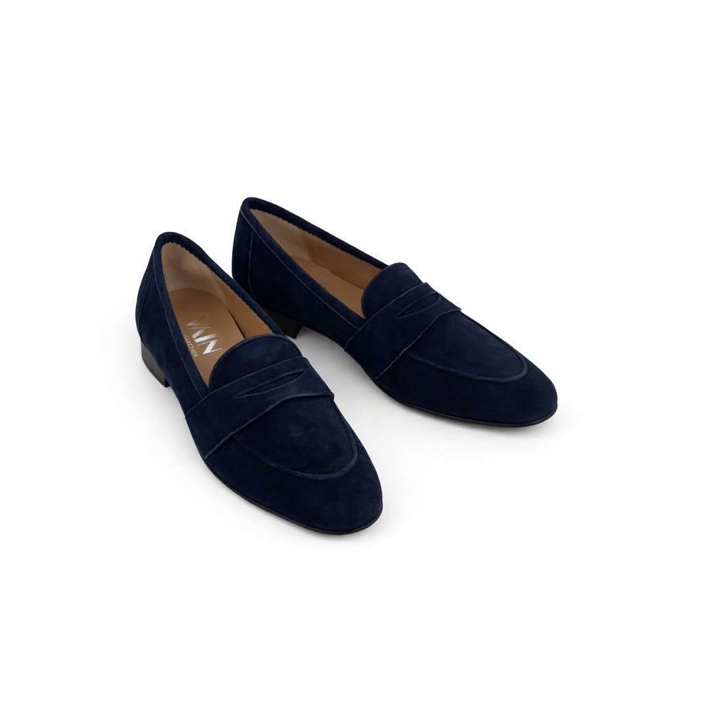 Pair of midnight blue loafers for women on a white background