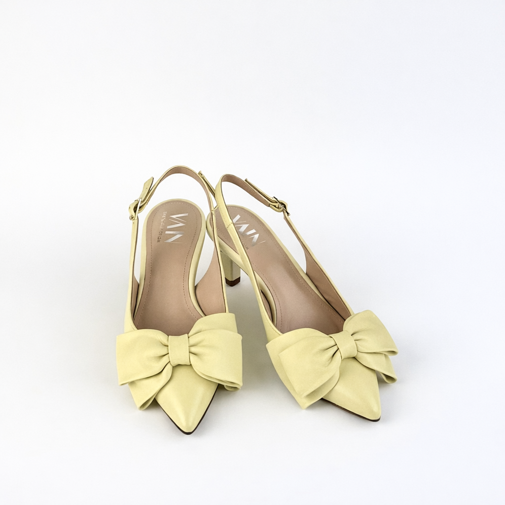 Pair_of_yellow_los-heeled_sling_back_shoes_with_large_bows_on_a_white_background