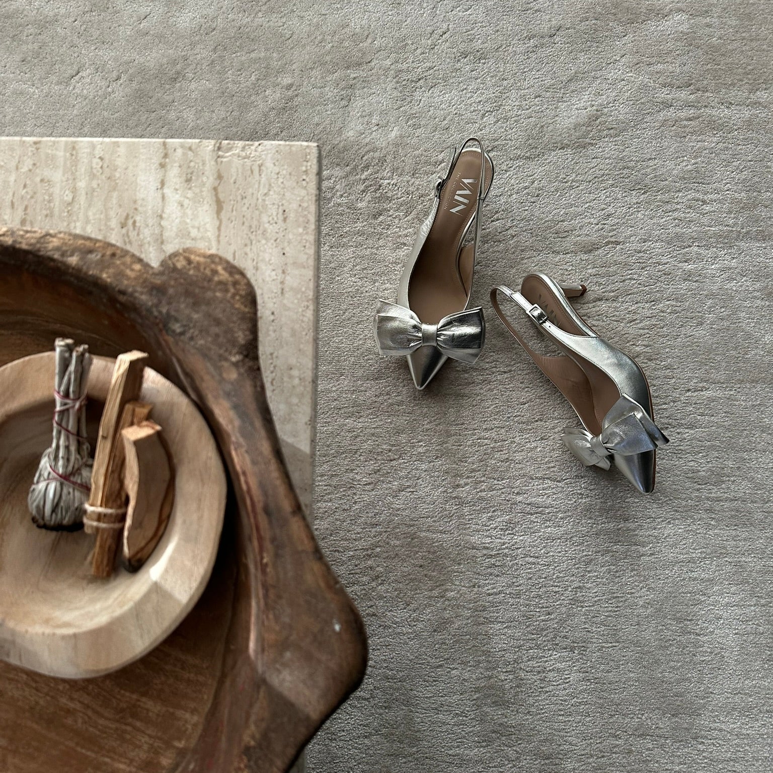 champagne kitten heels slingbacks on sandbeige carpet next to decoration