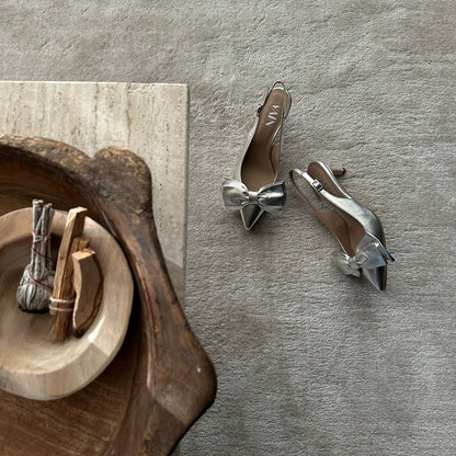 champagne kitten heels slingbacks on sandbeige carpet next to decoration