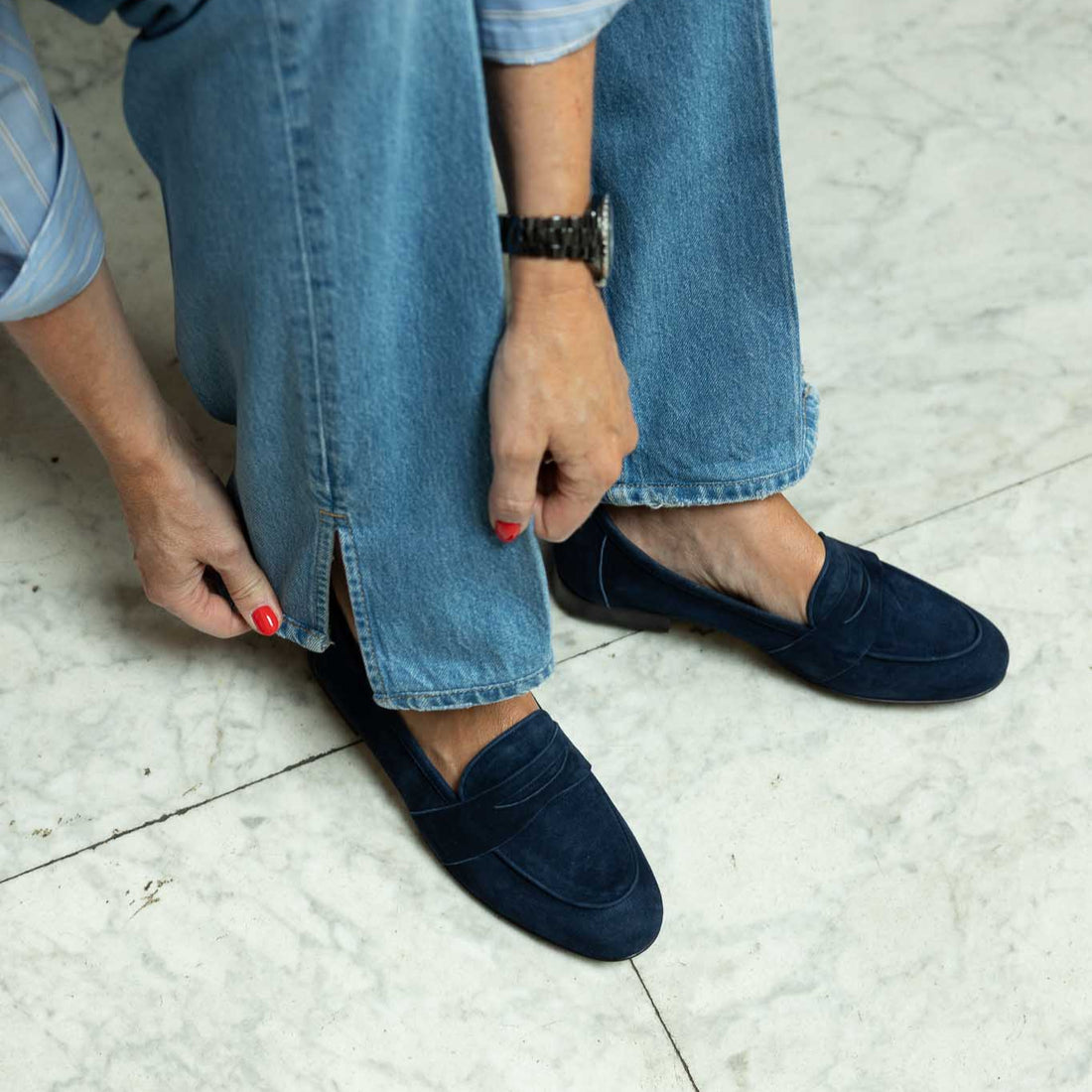 woman wearing blue jeans and blue suede loafers