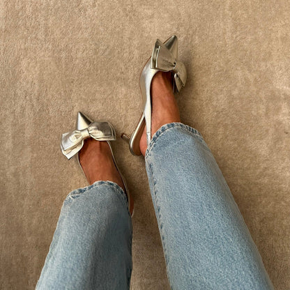 woman wearing light blue jeans and champagne slingback low heels in champagne colour
