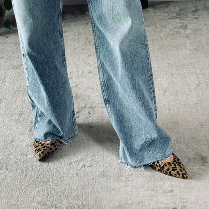 Woman wearing slingback kitten heels leopard print